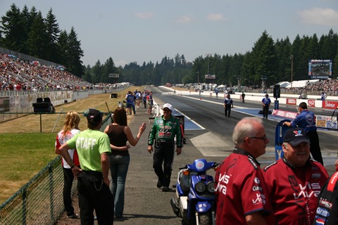 John Force walks toward his wife and third daughter